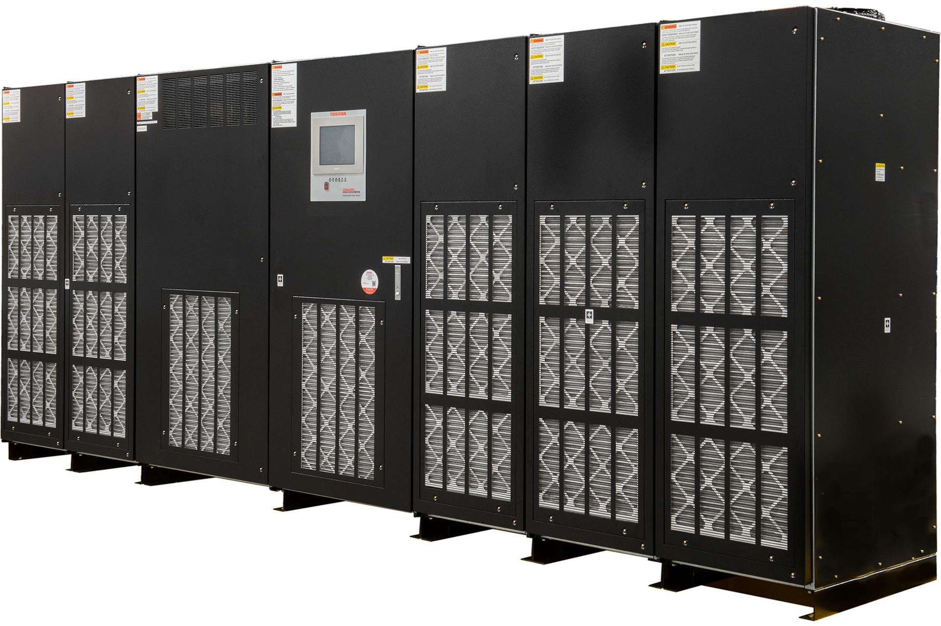 A row of large, black industrial equipment units with ventilation grilles and a control panel on one unit.