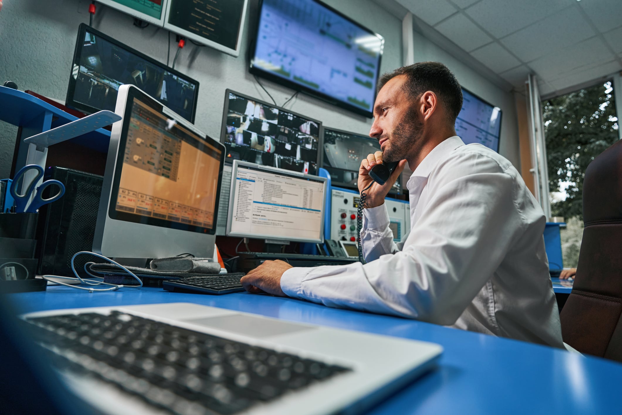 IT technician at a desk on the phone